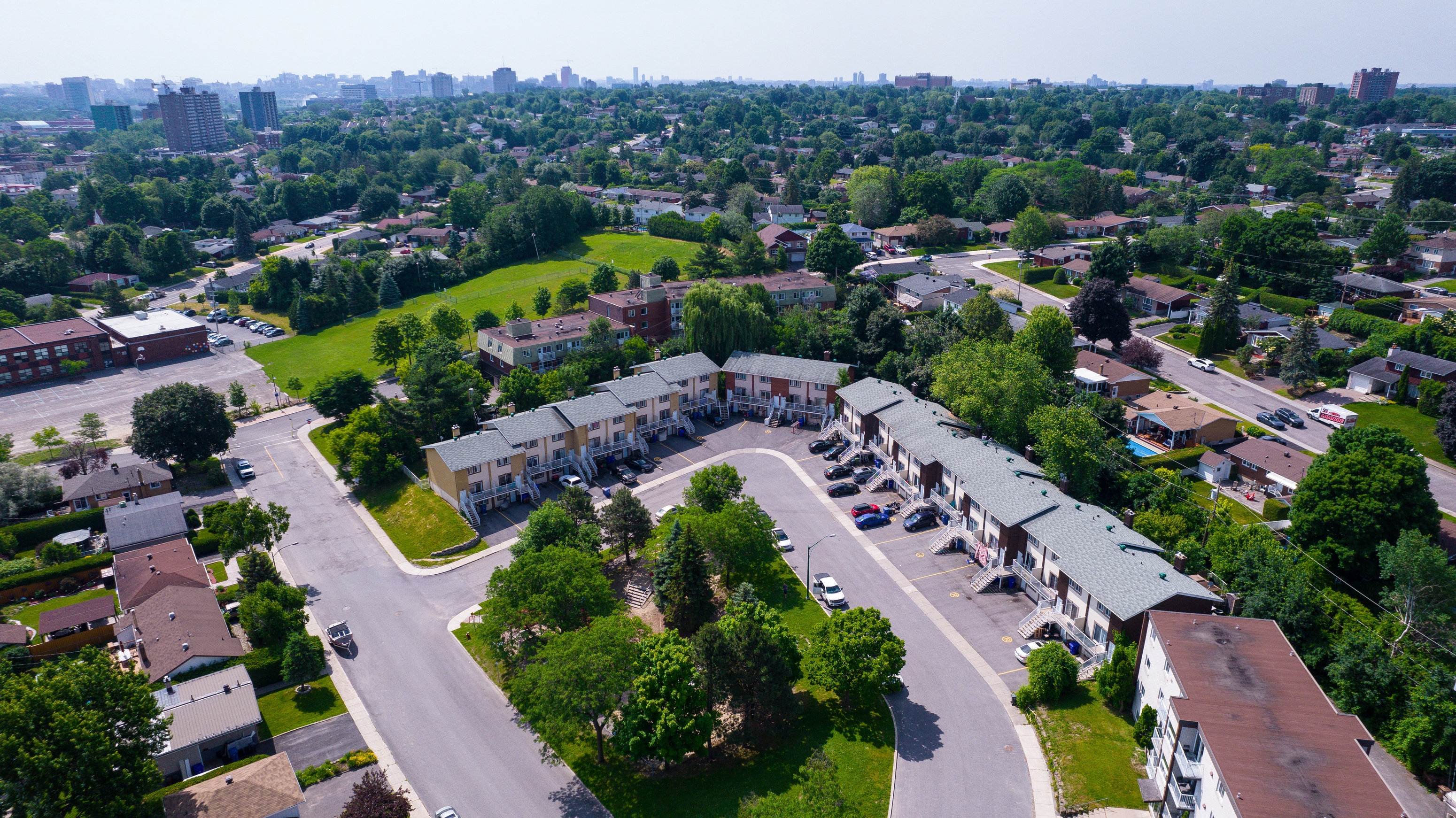 A bird's eye view of a residential area with houses and roads.